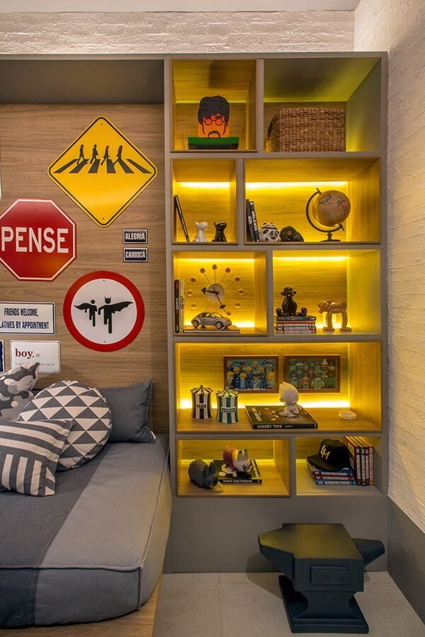 a bed sitting in a bedroom next to a shelf filled with books