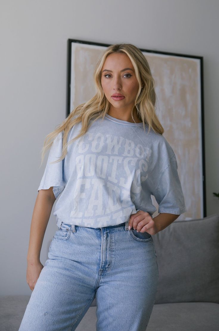 This Cowboy Boots & Faded Jeans Graphic Tee is perfect for a laid-back western look. It has a relaxed fit and features a stylish cowboy boot and jean design. Perfect for the rodeo or for any casual country style. baby blue fabric true to size / relaxed fit 100% cotton machine wash cold Casual Distressed Tops For Rodeo, Light Wash Tops For Rodeo In Spring, Relaxed Fit Denim Tops For Rodeo, Casual Relaxed Fit Tops For Rodeo, Casual Medium Wash Top For Rodeo, Casual Denim Top For Rodeo, Western Style Relaxed Fit Medium Wash Tops, Casual Fall Tops For Ranch, Western Style Washed Tops With Relaxed Fit