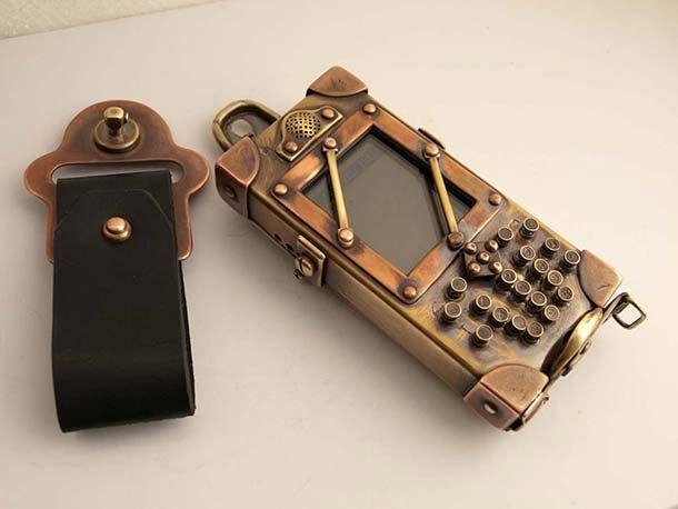 an old fashioned cell phone sitting on top of a table next to a key chain