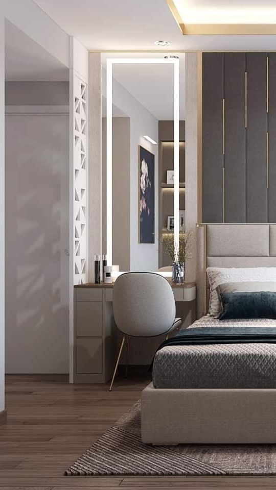 a bedroom with a bed, mirror and desk