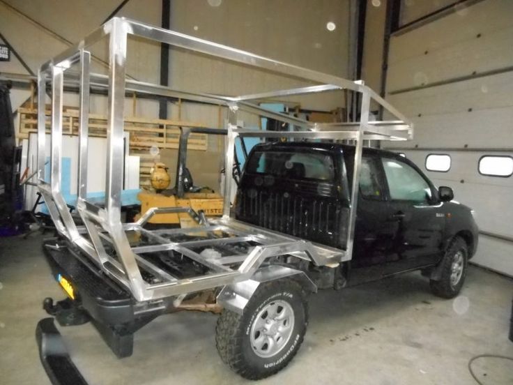 the truck is parked in the garage with its cage on it's back end