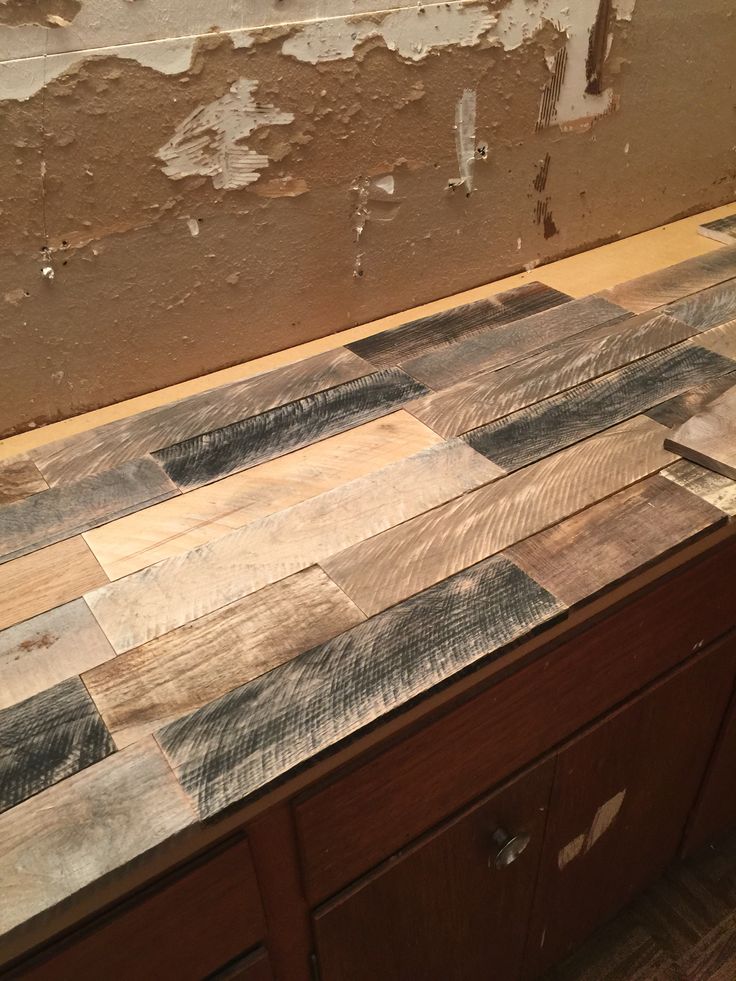 a wooden counter top sitting next to a wall