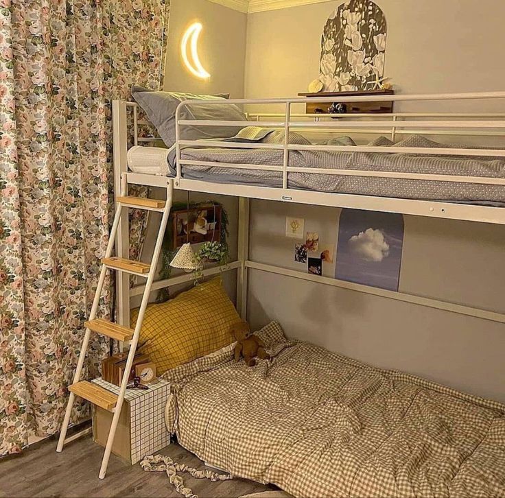 there is a bunk bed with a ladder on the bottom and a pillow under it