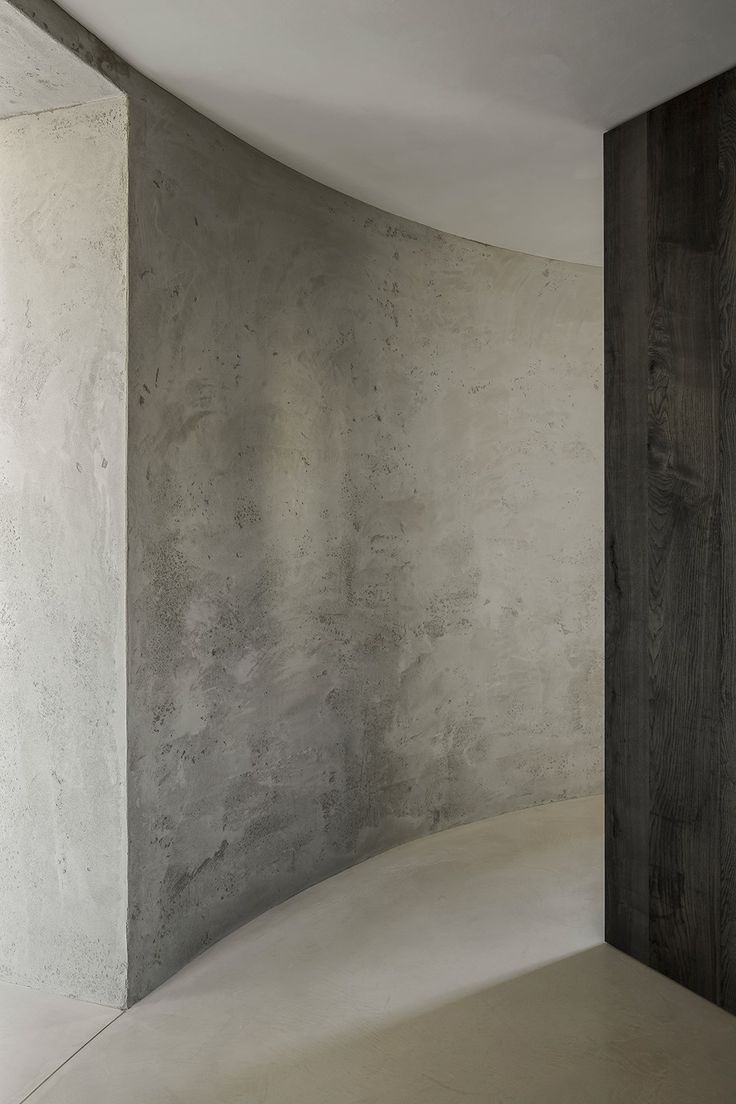 an empty room with concrete walls and floor