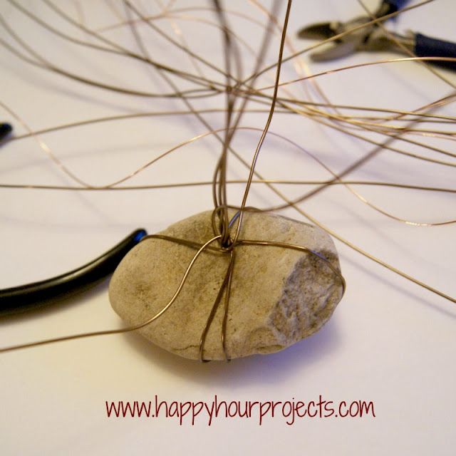 a rock with wire wrapped around it sitting on top of a table