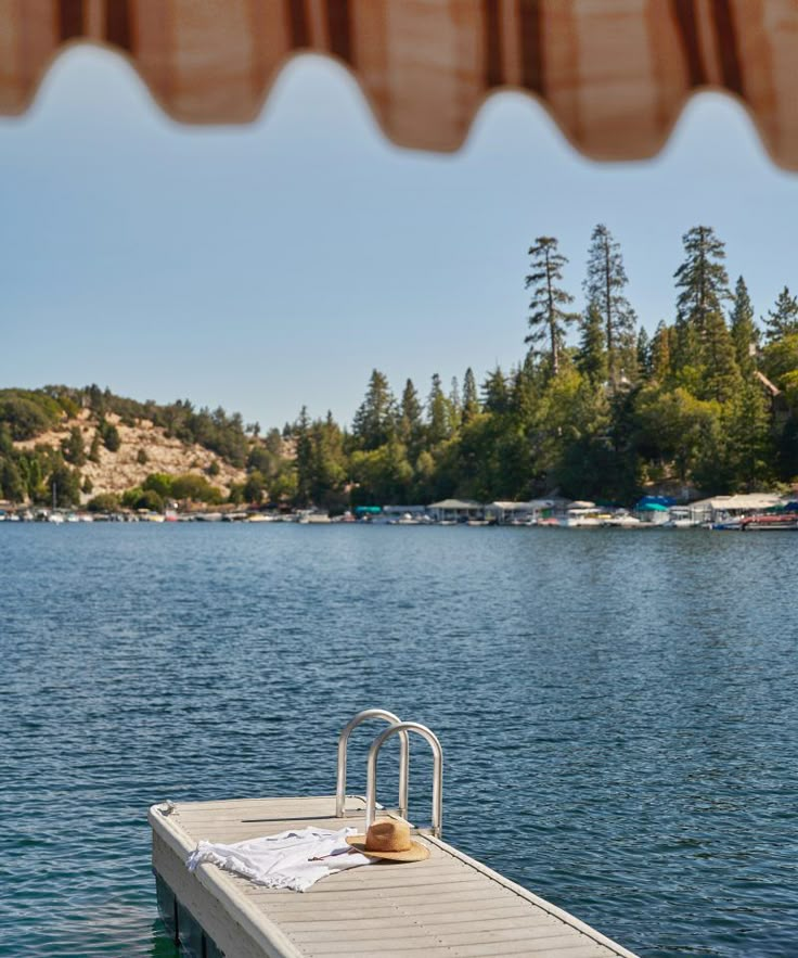 a boat dock with a towel on it in the middle of a body of water