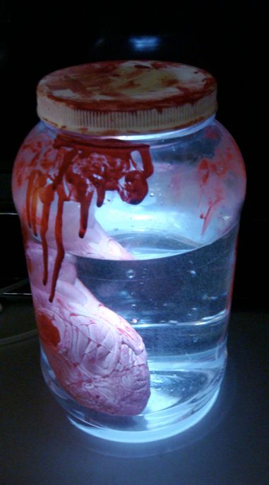 a jar filled with liquid and a heart shaped object