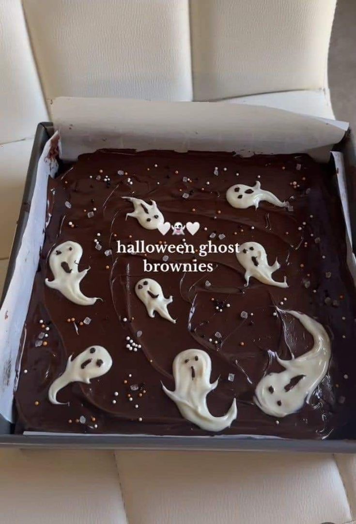 there is a chocolate cake with white frosting in the shape of ghost's