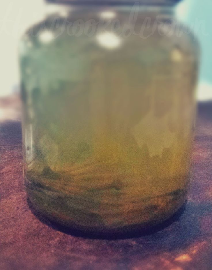 a glass jar sitting on top of a wooden table