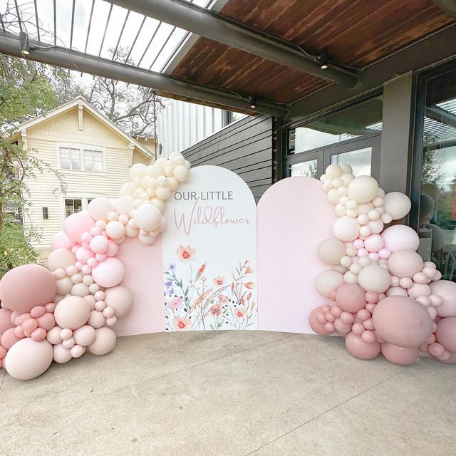 balloons are arranged in the shape of letters on a sign that reads our little miss