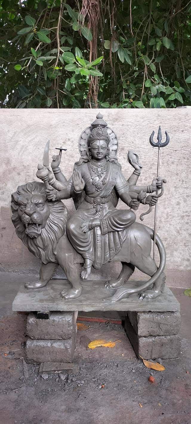 a statue of a person riding on a lion with a spear and two birds in their hands