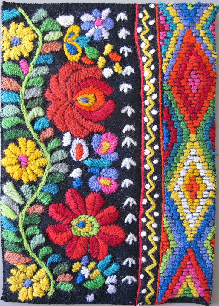 an embroidered bag with flowers and leaves on the front, in multicolored colors