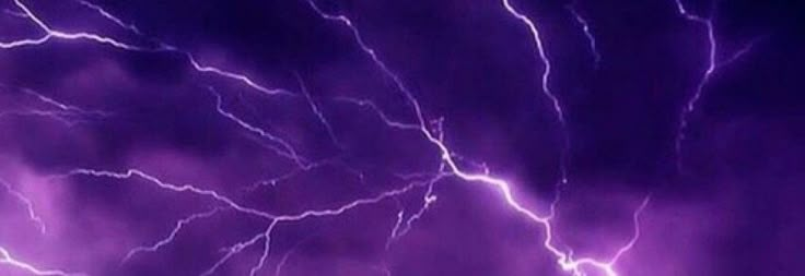 purple lightning strikes across the night sky