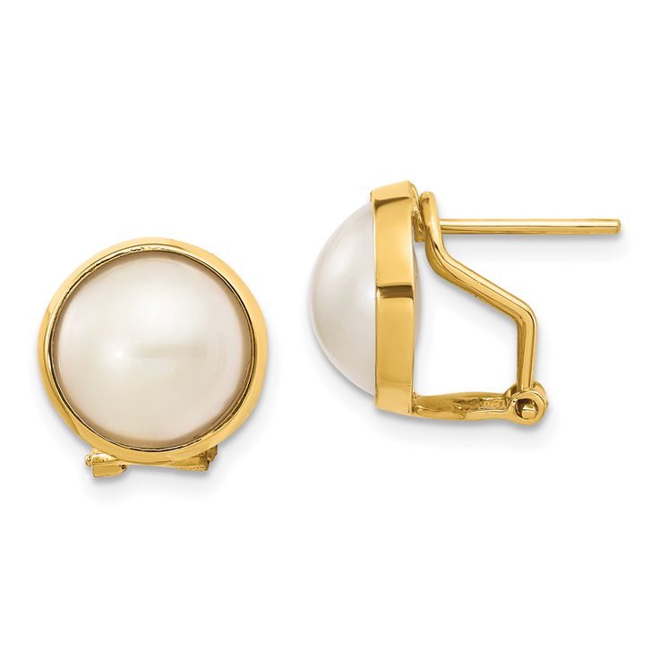 a pair of earrings with white pearls on the front and back of each earring