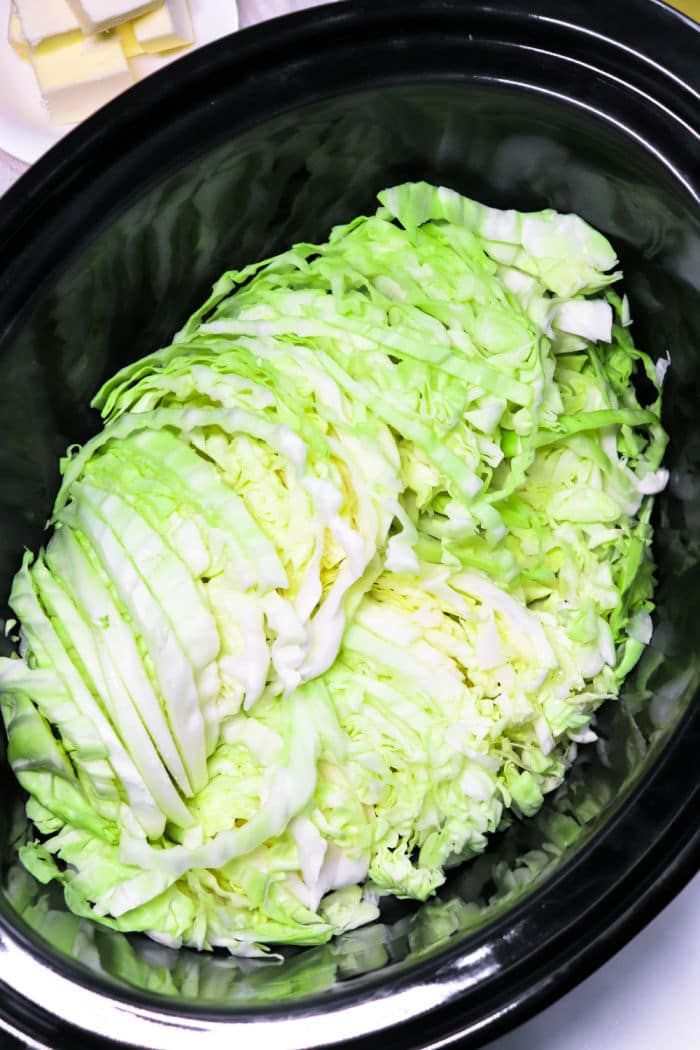 a bowl filled with lettuce sitting on top of a table