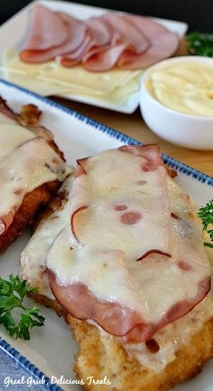 two plates topped with meat covered in sauce