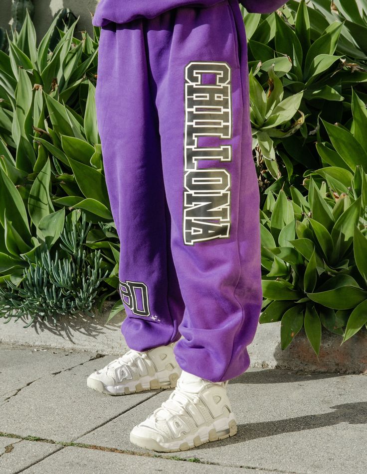 Pull up Crybbs, our latest Varsity sweats in this purple/black color way is a must have!! Show them off solo or pair them with the matching Chillona Varsity Sweater. We customized these sweats to have a baggy fit, so size down if you like your look a little more fitted. 40% Cotton 60% Polyester Casual Purple Cotton Sweatpants, Purple Relaxed Fit Sweatpants For Athleisure, Purple Relaxed Fit Sporty Sweatpants, Sporty Purple Cotton Sweatpants, Collegiate Relaxed Fit Sweats For Streetwear, Purple Athleisure Sweatpants For Loungewear, Purple Bottoms With Letter Print For Streetwear, Purple Letter Print Bottoms For Streetwear, Purple Cotton Sweatpants For Streetwear