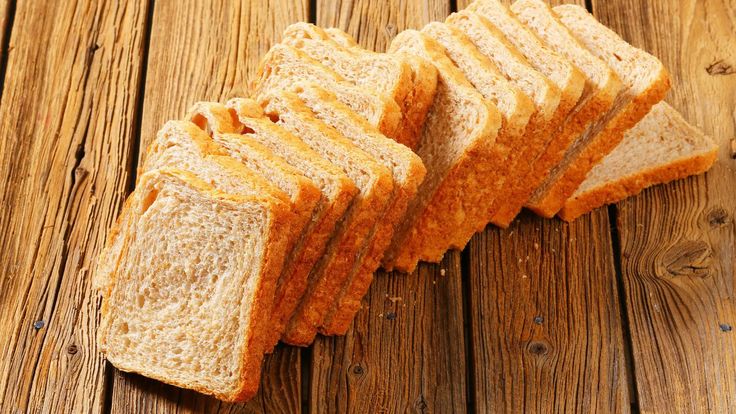 several slices of bread sitting on top of a wooden table