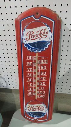 an old pepsi cola thermometer is on display