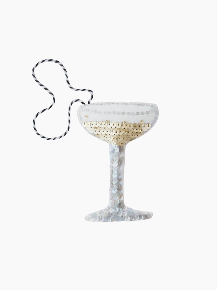 a white glass with a string attached to it on a white background, in the shape of a wine goblet