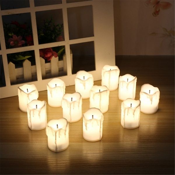 many lit candles sitting on top of a wooden table