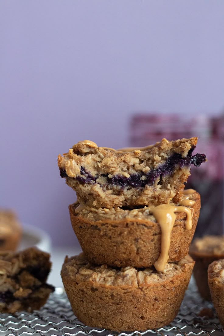 blueberry muffins stacked on top of each other with a bite taken out