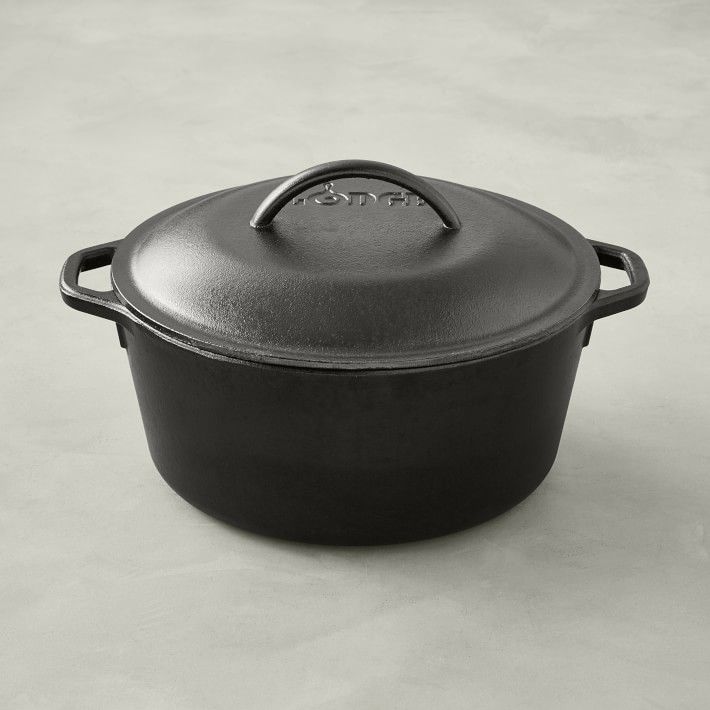 a black cast iron casserole sitting on a table