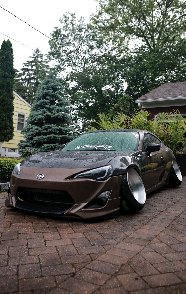 a sports car parked in front of a house