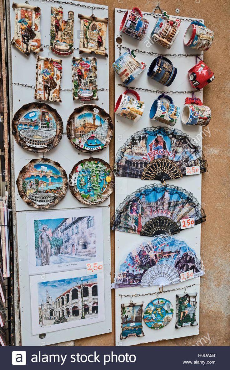 an assortment of souvenir and fan magnets on display in front of a wall