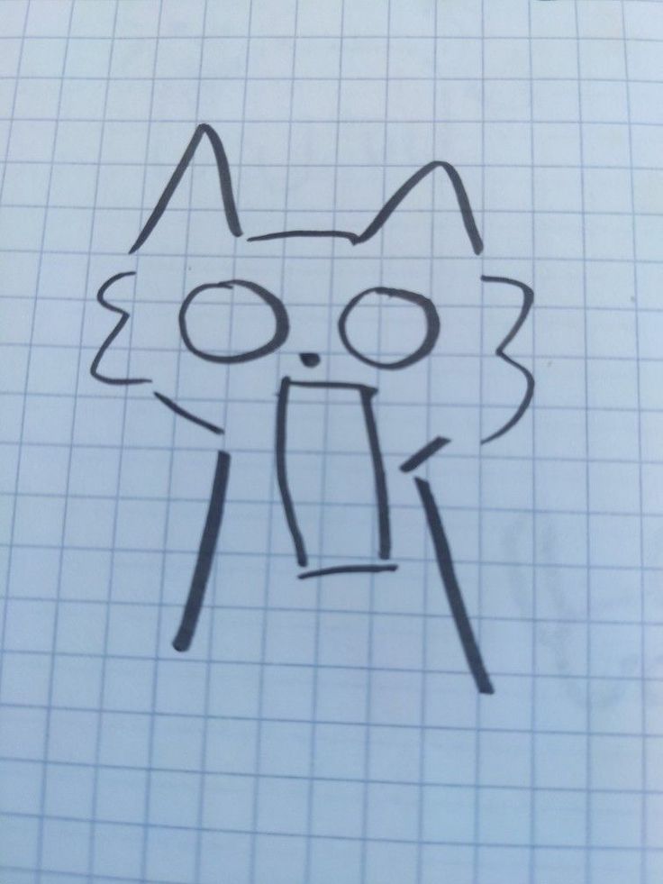 a drawing of a cat's face with its mouth open and tongue out on a sheet of paper