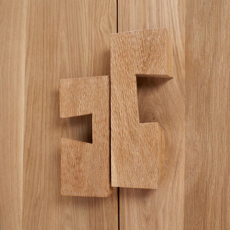 a close up of a wooden door with the letter f on it's side