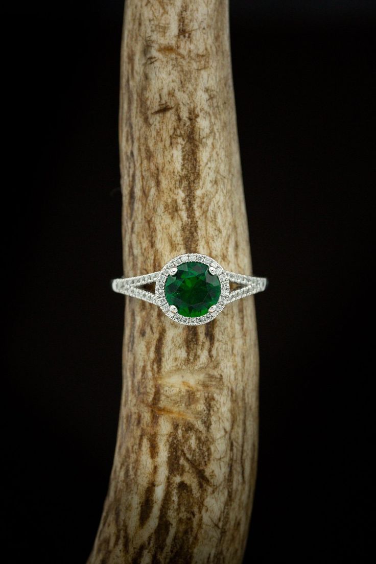 Product Details Ring Style:The "Aura" is a birthstone ring with a split shank-style & lab-created emerald women's ring with delicate and ornate details and is available with many center stone options Center Stone:7mm Round Lab-createdEmerald Materials: 14K gold engagement ring featuring a lab-created emerald center stone and a 1/5 ctw diamond halo and accents. Customizable:Because each of our rings is handcrafted to order, wecan customize yours using unique materials, gemstones, or design fe Emerald Cluster Ring With Halo Design, Promise Ring Halo With Prong Setting For May Birthstone, Promise Ring With Prong Setting For May Birthstone, Emerald Crystal Ring With Center Stone, Halo Diamond Ring For May Birthstone, Fine Jewelry Tsavorite Birthstone Ring, Emerald Ring With Halo Design For May Birthstone, Round Emerald Ring With Halo Design For May Birthstone, Halo Design Diamond Ring For May Birthstone