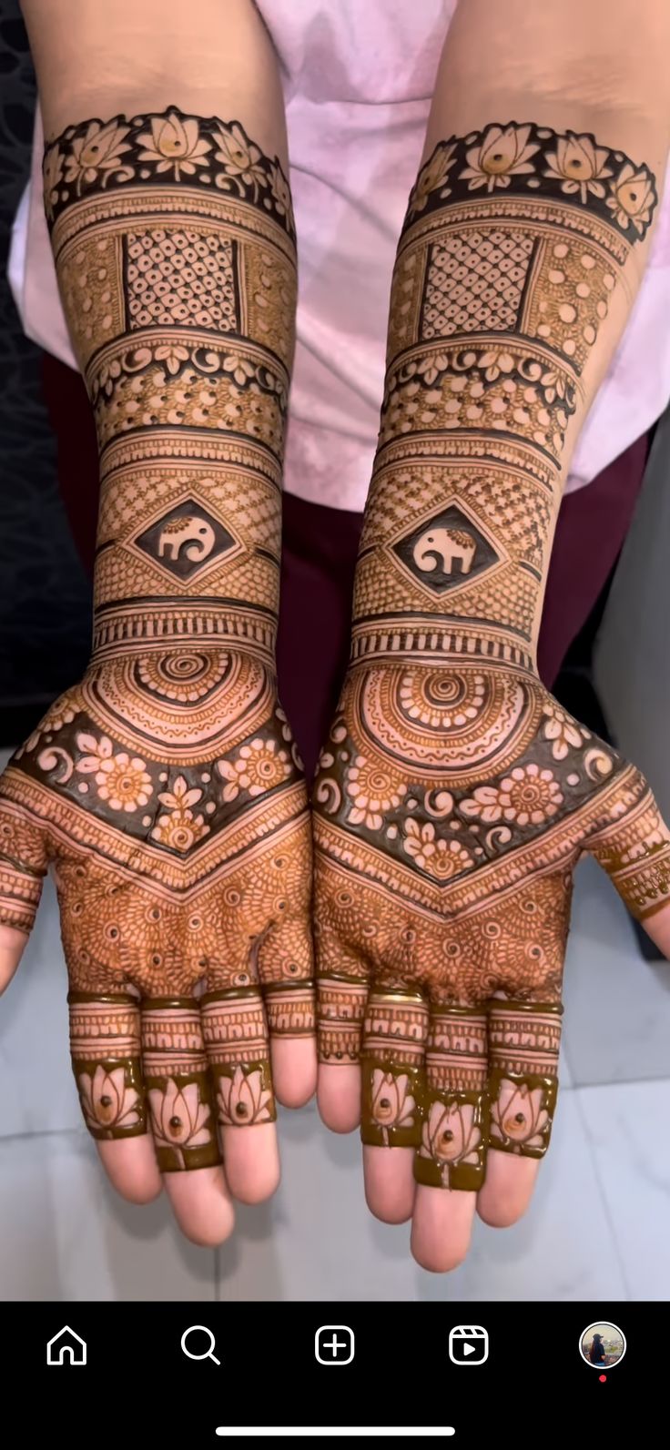 two hands with henna designs on them