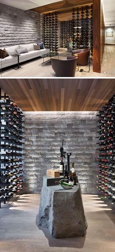 this modern wine cellar is built into the side of a stone wall and features a large rock table with bottles on it