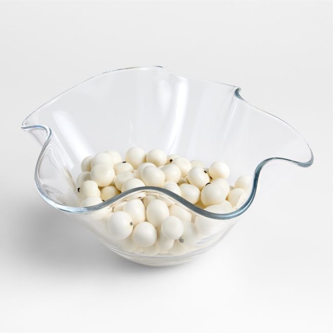 a bowl filled with white balls sitting on top of a table