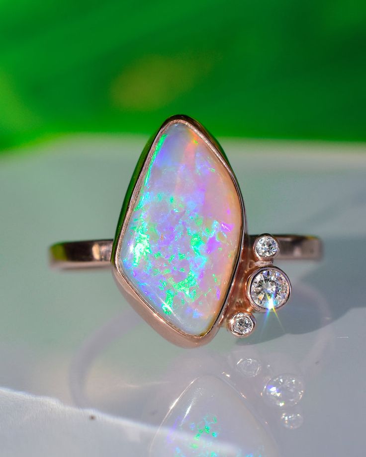 Asymmetrical Lavender/Peach/Dusty Pink Australian Opal with Emerald and Aqua Blue Fire Statement Ring paired with Diamond Accents in Solid 14k Rose Gold. 18mm in length.  This gorgeous Opal Statement Ring is made with the dreamy stone I cut the other day in a live! I love how she came out with the stone shape and layou Opal Statement Ring, Split Shank Ring, Heirlooms Jewelry, Blue Fire, Australian Opal, Gemstone Healing, Sparkle Diamonds, Statement Ring, Earings Piercings