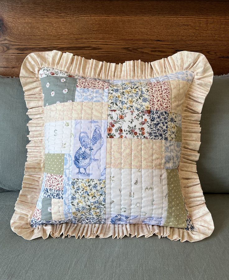 a close up of a pillow on a bed with a wooden headboard in the background