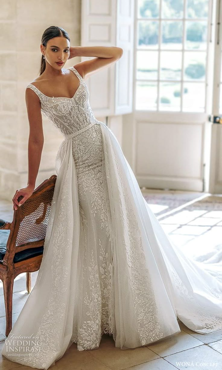 a woman in a wedding dress leaning on a chair