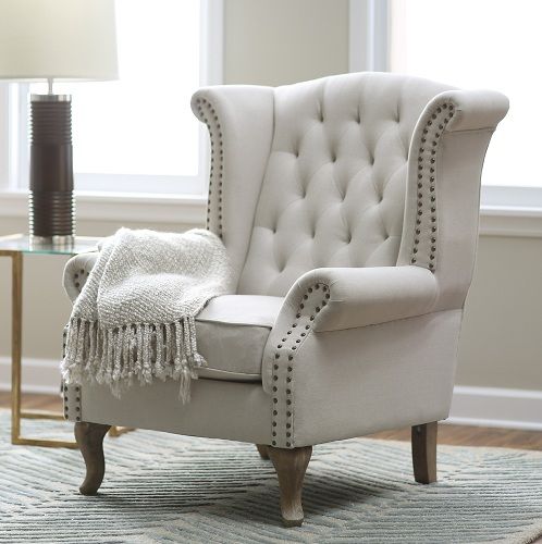 a white chair sitting on top of a rug