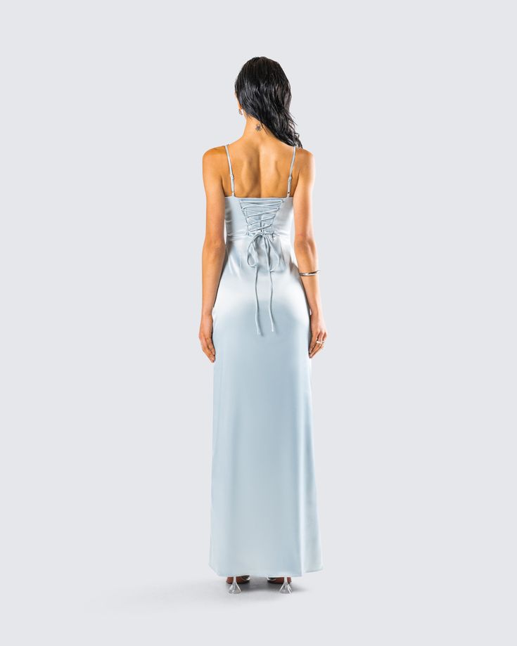 the back of a woman in a light blue dress