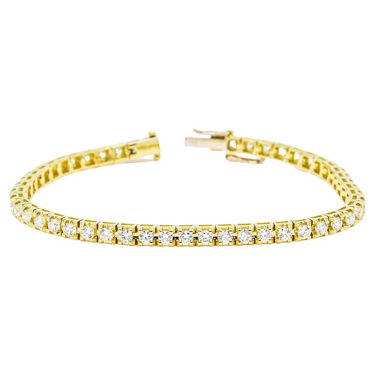 Elevate your style with this exquisite 18K Yellow Gold Four Prong Tennis Bracelet. Crafted with meticulous attention to detail, it features a continuous line of dazzling round-cut natural diamonds, totaling 8.00 carats. Each diamond is expertly hand-set in a secure four-prong setting, allowing for maximum brilliance and light reflection. The warm tones of the 18K yellow gold complement the diamonds beautifully, creating a radiant and luxurious piece that is sure to captivate. This tennis bracelet is designed to be a showstopper, commanding attention with its brilliant display of 8.00 carats of natural diamonds. The meticulously crafted links ensure a comfortable fit, while the secure four-prong settings offer both protection and an enhanced showcase of the diamonds' beauty. Whether worn as Bracelet Tennis, Continuous Line, Light Reflection, Tennis Bracelet, Elevate Your Style, Elegant Gift, San Valentino, Diamond Shapes, Prong Setting