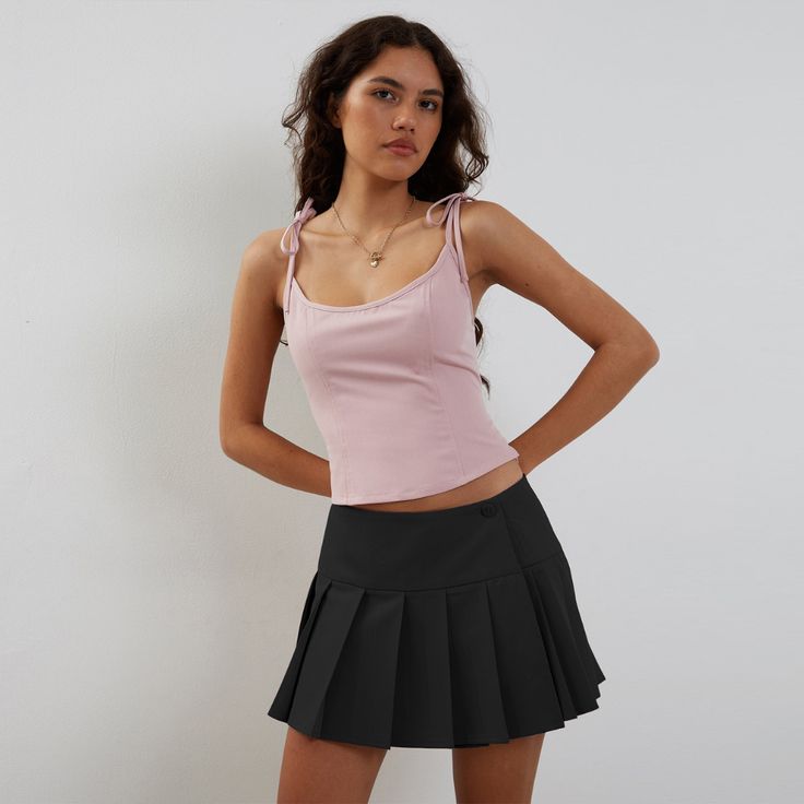 Indulge in the sophisticated style of our Preppy Hottie Pleated Skirt. Its elegant pleats and luxurious fabric create a tastefully exclusive look. Perfect for any occasion, this skirt is a must-have for any fashion lover. Elevate your wardrobe with this premium piece. Features: -85% Polyester -Low Waist -Solid Color -Pleated Design -Regular fit -Preppy style Chic Pleated Mini Skirt In Color, Chic Midi Skort With Pleated Details, Pleated Flared Mini Skirt In Feminine Style, Party Mini Skirt With Pleated Hem, Flirty Pleated Skirt For Party, Chic Fitted Ruffled Tennis Skirt, Chic Fitted Tiered Tennis Skirt, Solid Color Pleated Tiered Skort, Chic Party Tennis Skirt With Lining