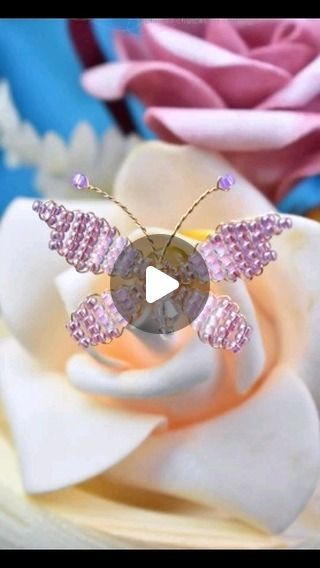 a close up of a flower with a butterfly brooch on it's back