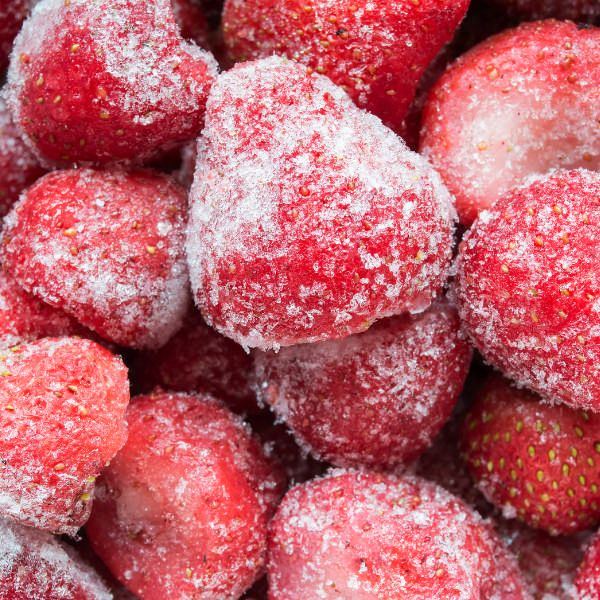 some strawberries are covered in powdered sugar and sit on top of each other