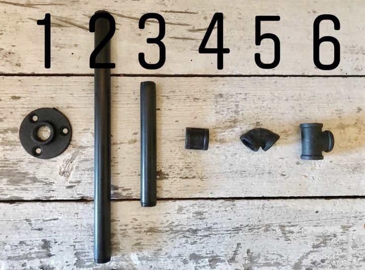 the numbers are displayed on an old white wooden wall with screws and nuts in it