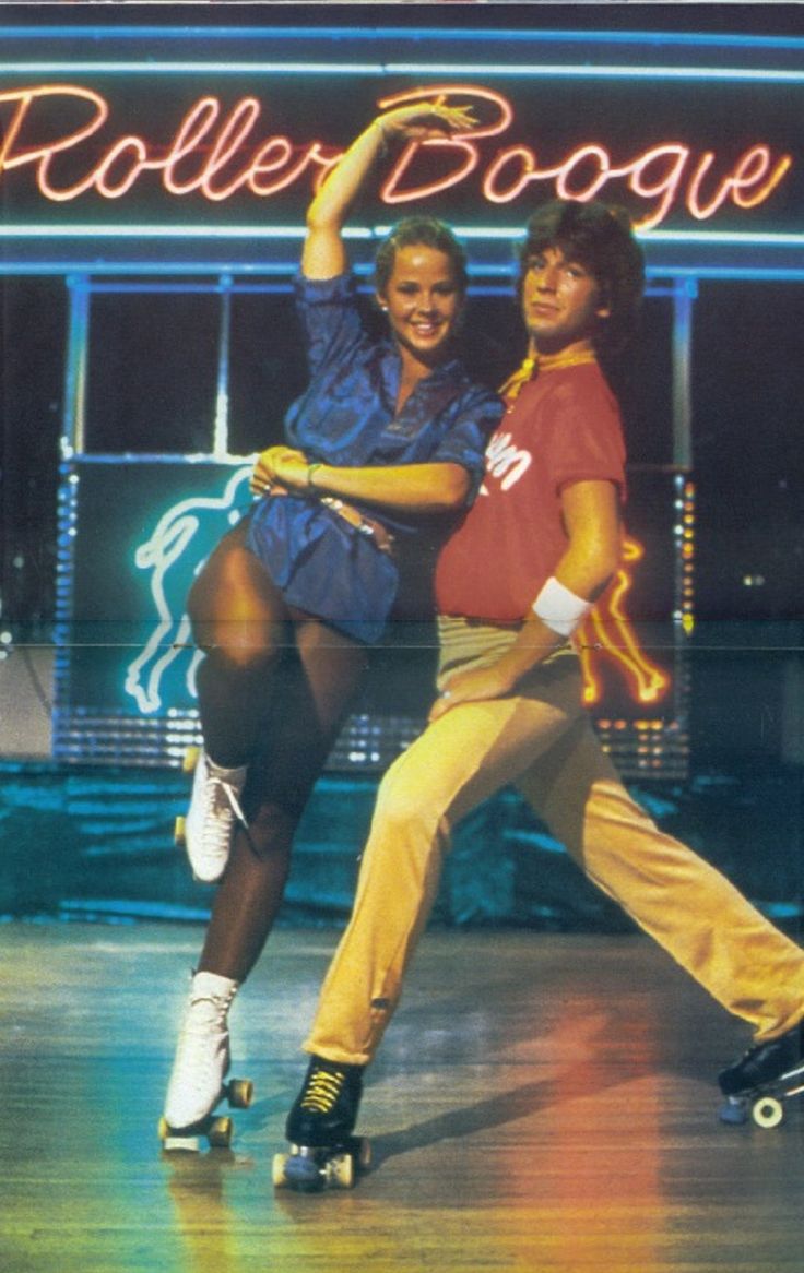 two people on roller skates in front of a neon sign that says roller boogie