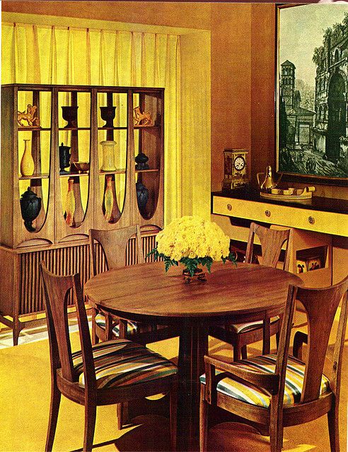 a dining room with yellow walls and chairs