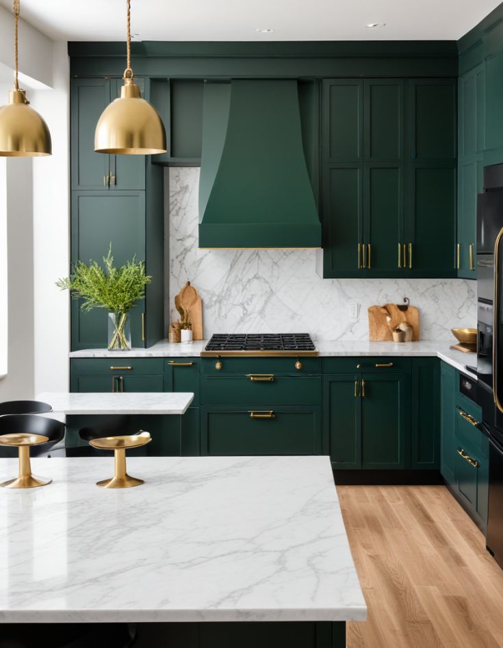 a kitchen with green cabinets and marble counter tops, gold accents on the hoods