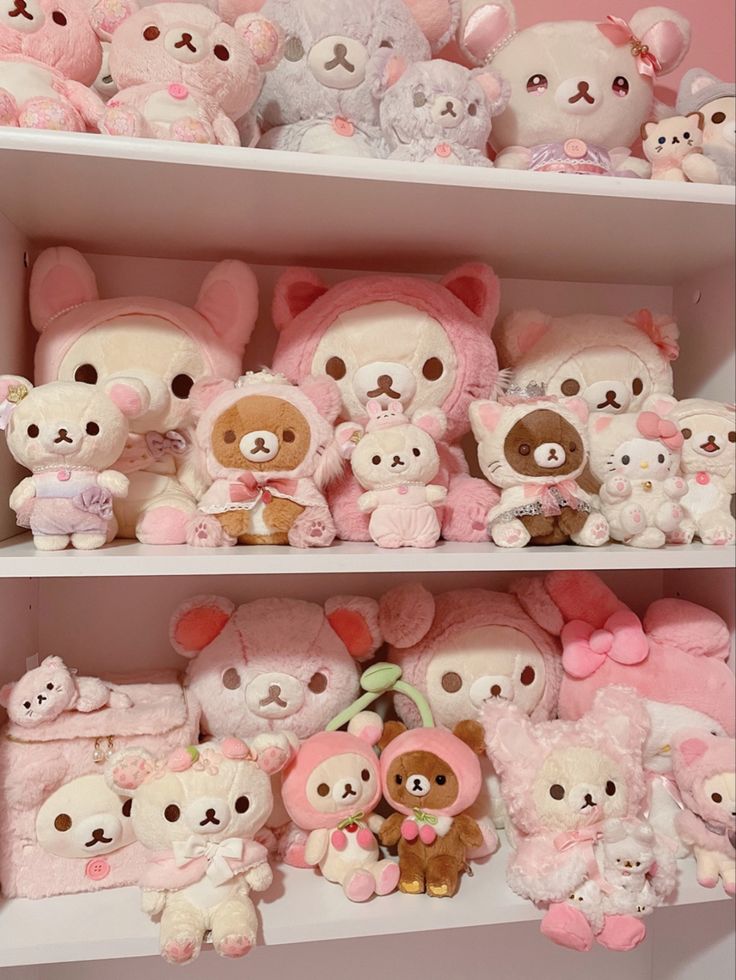 many stuffed animals are on shelves in a room with pink walls and white shelving