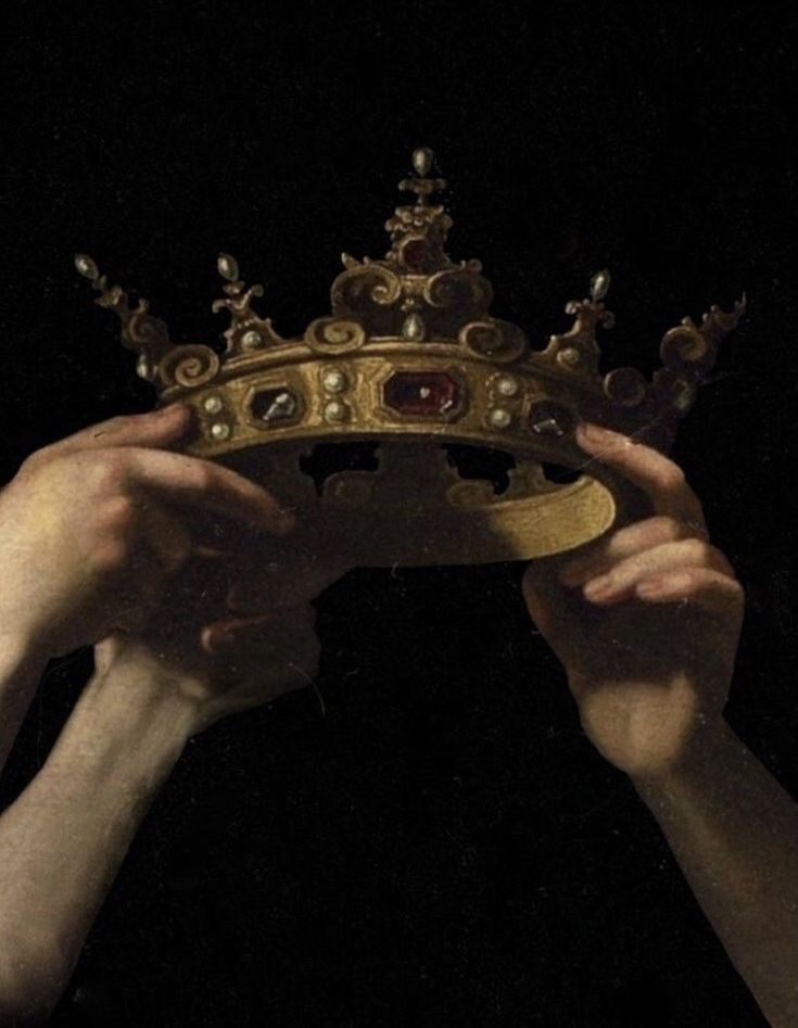 two hands holding up a crown in the dark